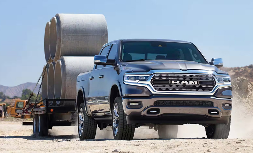 The 2023 Ram 1500 towing a trailer with cement