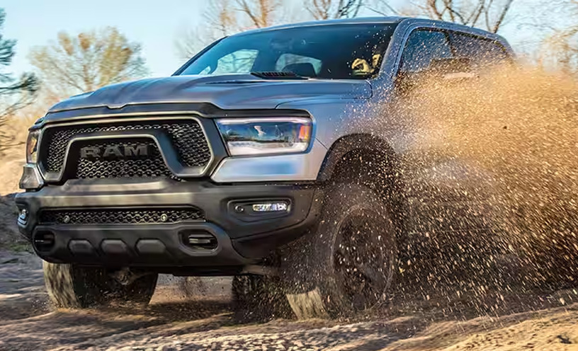 The 2023 Ram 1500 Rebel being driven off-road with dirt